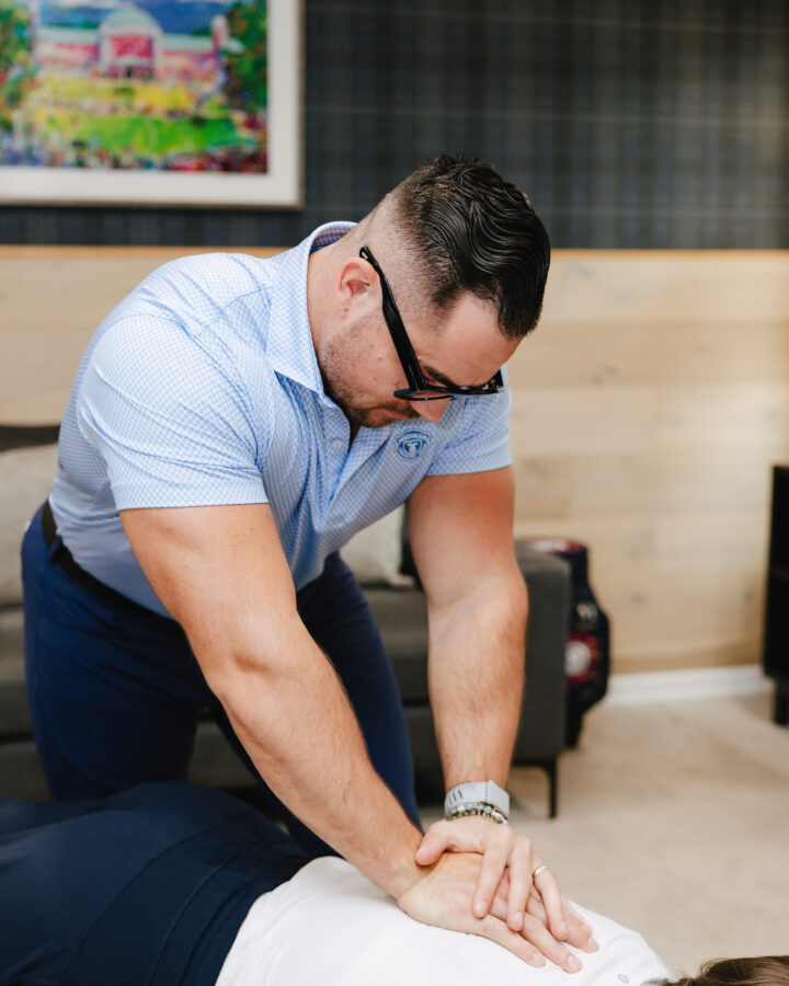Chiropractor performing a table-assisted chiropractic adjustment